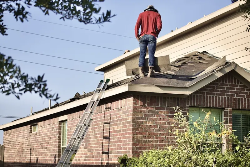 Professional roofer working on a residential roof in Maydale